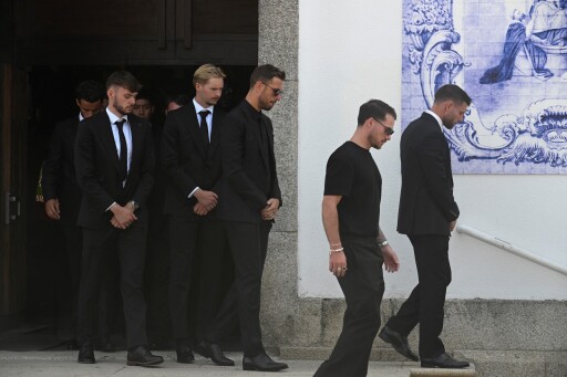 Liverpool's team players step out of the church after the funeral ceremony for Liverpool's Portuguese forward Diogo Jota and his brother Andre Silva at the Mother Church of Gondomar, on the outskirts of Porto, on July 5, 2025. Liverpool forward Diogo Jota and his brother died in a car crash in Spain on July 3, 2025, sparking widespread grief just after the Portugal star had got married. (Photo by MIGUEL RIOPA / AFP)